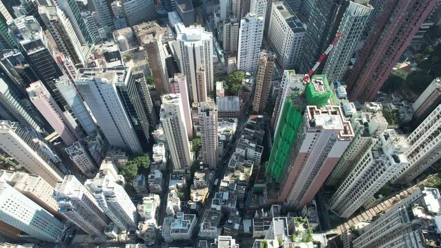 City skyview in 4K Aerial drone shot of the Mid-Levels, is an affluent residential area in Hong Kong, located between Victoria Peak and Sheung Wan Central. Residents are affluent and expatriate profes