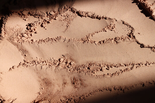 Background of brown sandy powder. concept of beauty, texture and cosmetics mock up