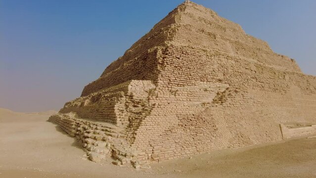 Saqqara, Egypt: Exterior view of the famous Djoser step pyramid in the Sakkara necropolis near Cairo in Egypt is the oldest large pyramid dating to 4500 years with a tilt up motion 