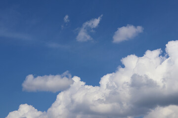 Blue sky background with white clouds. Cumulus white clouds in the blue sky.