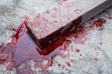 blood spills on the floor. concept photo for illustration of suicide and wooden beams to kill