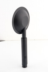 The black hand shower features a sleek, modern design that adds a stylish touch to any bathroom.