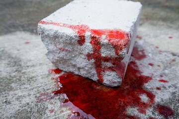 blood spills on the floor. concept photo for illustration of suicide and brick to kill