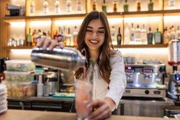 Female bartender making alcoholic cocktail on the bar counter, Young professional bartender working...