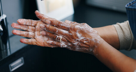 Person, soap and washing hands for hygiene, germ or bacteria removal by tap or sink at home. Closeup of palm in skincare, protection or soapy skin for cleaning, dirt or disinfection by basin at house