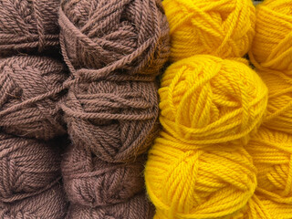 Multicolored knitting yarn close-up. Top view. Brown and yellow yarn.