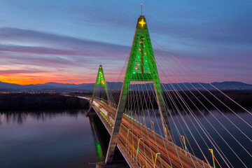 Obraz premium Aerial view about the illuminated Megyeri bridge in a rare christmas decorations at sunset.