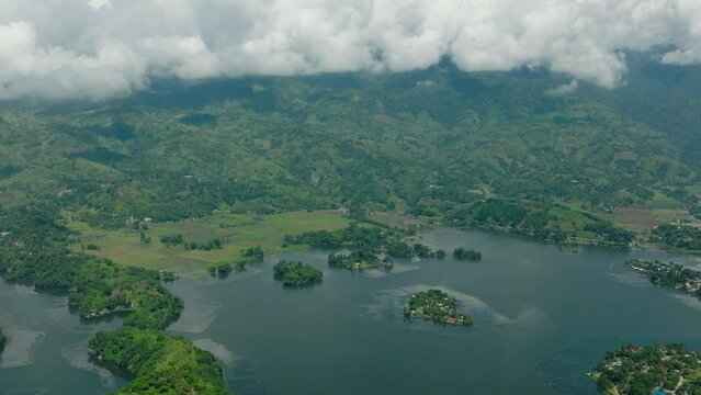 Beautiful view of Lake Sebu surrounded by forest and farmland. Blue sky and clouds. Mindanao, Philippines. Travel concept.