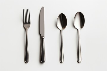 A set of silverware consisting of a knife, fork, and spoon. Suitable for use in various dining and culinary concepts