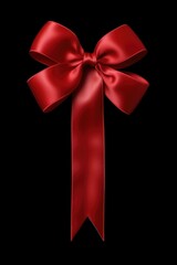 A simple and elegant red bow placed on a black background. Perfect for adding a touch of sophistication to any project