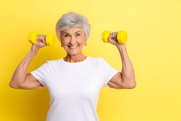Senior Caucasian woman doing exercise with dumbbell