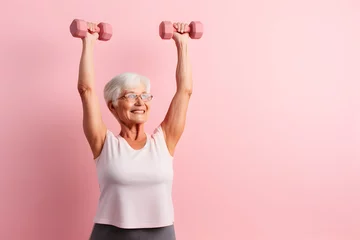 Foto op Plexiglas Senior Caucasian woman doing exercise with dumbbell © ZayNyi