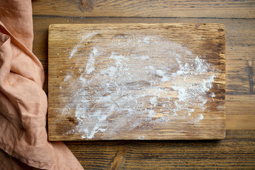 flour on wooden cutting board