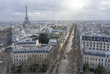 Fototapeta premium Paris, France - January 14th 2019 : View of Paris from the triumphal arch with two avenues and the Eiffel tower in the background.