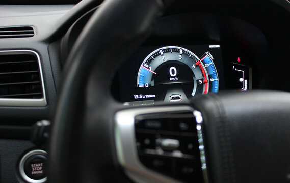 Digital tachometer with colored backlight on the central panel of a modern car