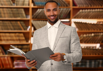 Lawyer, consultant, business owner. Confident man with file folders smiling indoors