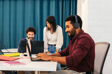 Group of multiracial people working with laptop in a coworking
