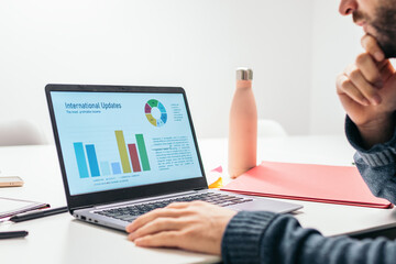 Close-up of a man analyzing company data on a laptop