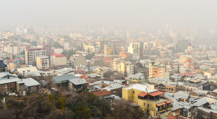 Obraz premium Vake and Vera neighborhoods covered with fog scenic view from Mtatsminda mountain (Tbilisi, Georgia) 
