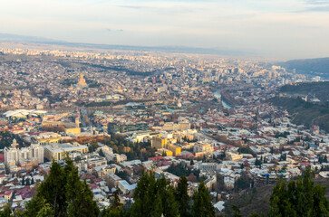 Fototapeta na wymiar Tbilisi at sunset panoramic view from Mtatsminda Park