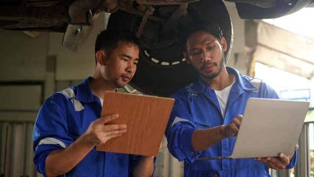 Team of car repairman technician consultation checking car engine and inspection vehicle damage broken part condition, technical service repair maintenance at garage automotive