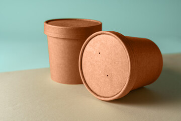 Empty paper Biodegradable cups containers for food and soup on the background of Trendy color of year 2024 - Peach Fuzz.