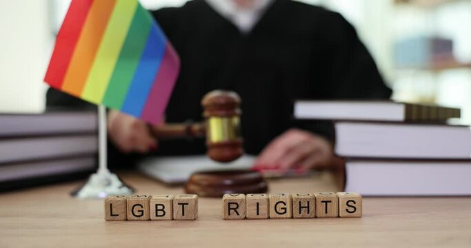 Judge gavel symbol of law and justice with lgbt flag in rainbow colors. LGBT rights and law