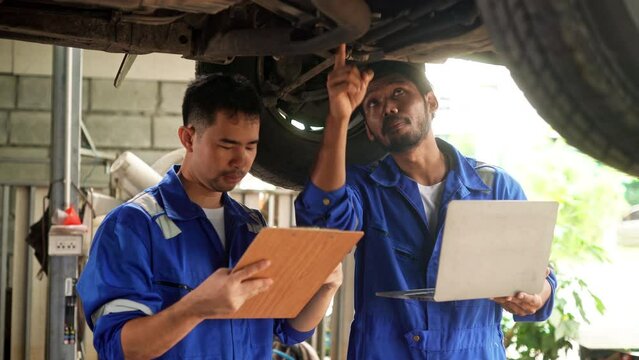 Team of car repairman technician consultation checking car engine and inspection vehicle damage broken part condition, technical service repair maintenance at garage automotive