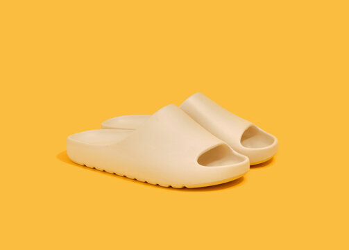 Summer flip flops on a yellow background. Comfortable stylish shoes for men and women.