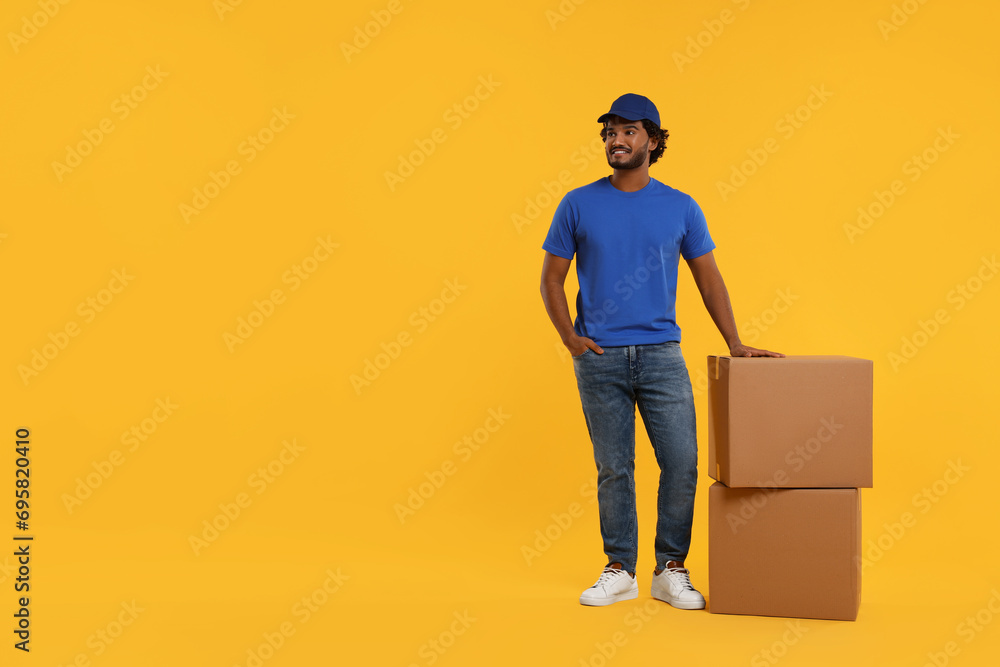 Sticker Happy courier with parcels on orange background, space for text