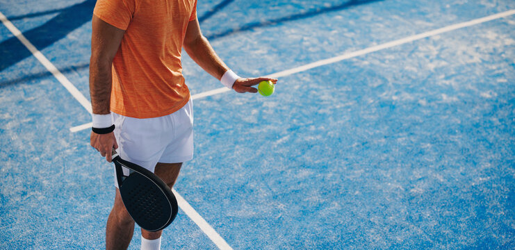 Athlete preparing to hit a serve in a padel match