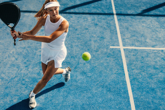 Woman playing with impressive padel skills in a sports competition