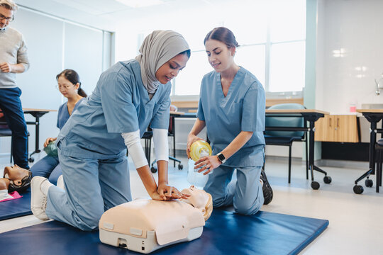 Chest compressions in clinical simulation: Female medical students practicing cpr on a manikin