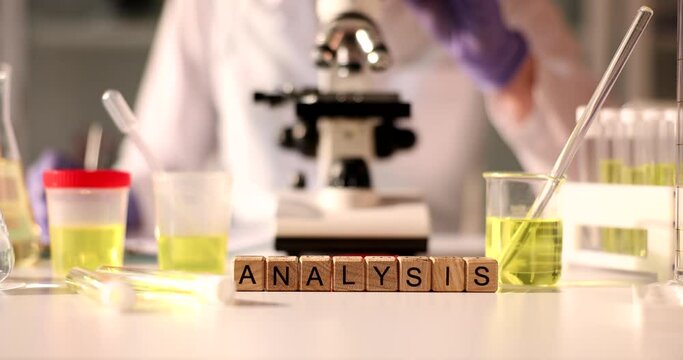 Urinalysis Word on background of microscope and jars in laboratory closeup. General clinical analysis of urine and physical and chemical examination of urine