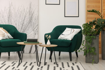 Comfortable armchairs and nesting tables in stylish room