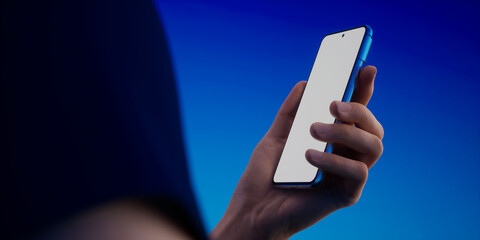 Caucasian man using phone on a vivid blue background, blank screen mockup