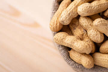 Close up of peanuts. Background of unpeeled peanuts in linen sack