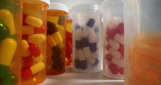 Pharmaceutical industry and different pills in jars. Overview of global pharmaceutical industry