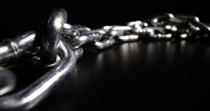 Chrome plated metal chain steel chain on black background. Metal links in a chain