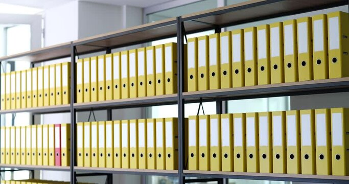 Red folder moves quickly among yellow ones. Archiving of business documents