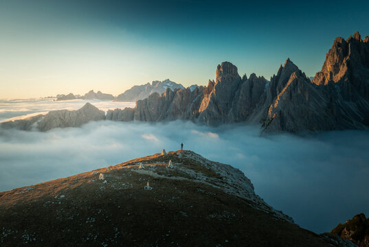 Majestic Sunrise Over Tre Cime Dolomites: Aerial View of Mountain Peaks in Tranquil Cloud Inversion