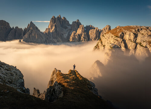 Majestic Sunrise Over Tre Cime Dolomites: Aerial View of Mountain Peaks in Tranquil Cloud Inversion