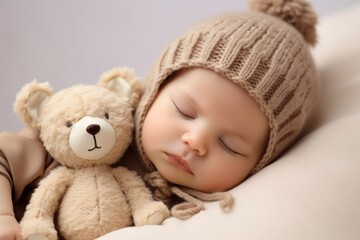 a cute sleeping baby with a teddy bear.