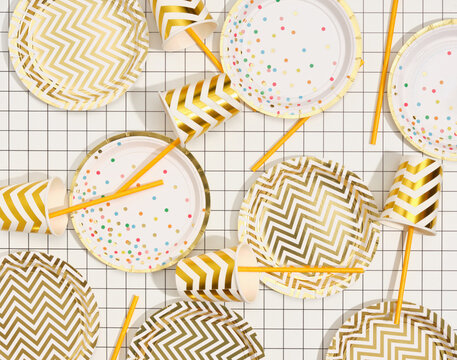 Image of stylish birthday beautiful table setting. Top view of plates, cups and straws.