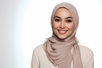 Young beautiful Middle East woman wearing hijab or headscarf with flawless healthy skin smiling to camera on white background. Female Muslim model for skin care ads. Female Muslim fashion ads. 