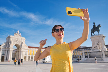 Tourist visiting Lisbon, Portugal - Happy woman taking selfie picture outdoors - Travel, tourism...