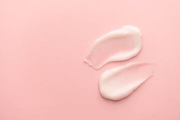 Skincare cream smear on pink background. Cosmetic lotion swatch texture of face cream, body...