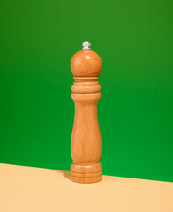 Wooden pepper shaker on table. Food preparation, kitchen work.