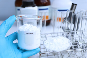 L-GLUTAMINE powder in chemical container , chemical in the laboratory and industry