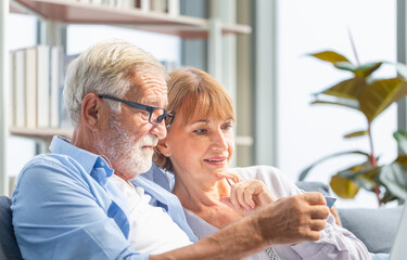 Close-up of Senior couple wife and husband with laptop online shopping at home, Handsome old man holding credit card in hands